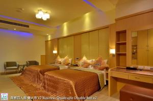 Postel nebo postele na pokoji v ubytování Zheng Yi Classic Hotel & Motel