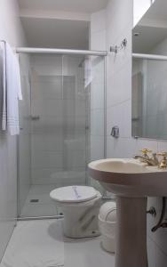 a bathroom with a shower and a toilet and a sink at Hotel Santa Maria in Campo Mourão +59 photos