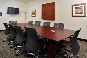 a conference room with a wooden table and chairs at Staybridge Suites Sioux Falls at Empire Mall by IHG in Sioux Falls +40 photos