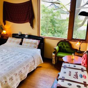 Ein Bett oder Betten in einem Zimmer der Unterkunft ガーデンハウス Mako Land