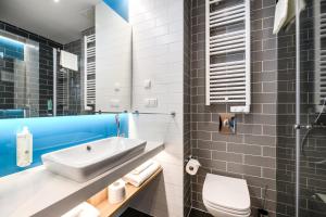 a bathroom with a sink and a toilet at Holiday Inn Express - Rzeszow Airport by IHG in Rzeszów +34 photos