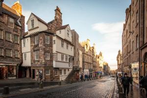 a city street with buildings and people walking down the street at Holiday Inn Express Edinburgh – Royal Mile, an IHG Hotel in Edinburgh