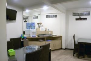 a room with a table and chairs and a tv at Bantal Guling Trans in Bandung