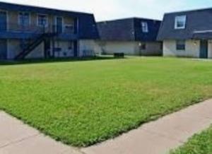 a large grassy yard in front of a building at 2 bed/ 1 bath next to Ft. Sill in Lawton