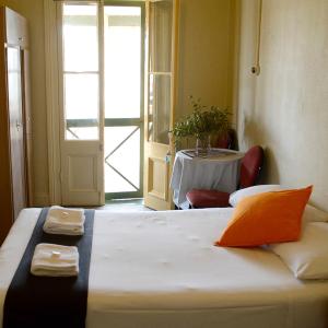 a bedroom with a bed with a table and a window at Shamrock Hotel Motel Temora in Temora