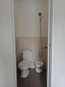 a bathroom with a toilet and a bidet at DMS Apartelle in Los Baños +2 photos