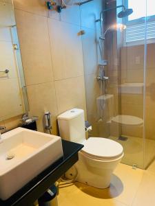 a bathroom with a toilet and a sink and a shower at Ralla Nilaveli in Nilaveli