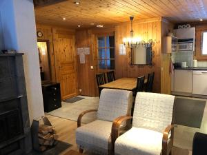 a kitchen with a table and chairs and a fireplace at Ruka Rantaruka 6 in Ruka