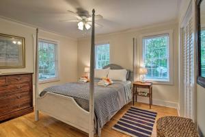 a bedroom with a bed and a ceiling fan at Savannah Cottage - 5 Mi to Wormsloe Historic Site! in Savannah