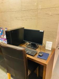 a desk with a laptop computer and a keyboard at Ueno Touganeya Hotel in Tokyo