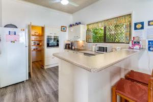 a kitchen with white appliances and a white refrigerator at Keith's Place, 1 of the 4 most popular units on Bribie in Bongaree