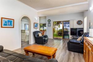 a living room with a couch and chairs and a table at Keith's Place, 1 of the 4 most popular units on Bribie in Bongaree