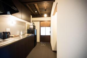 een kleine keuken met een wastafel en een koelkast bij Higashiyama Kageroi in Kanazawa