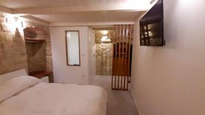a bedroom with a bed and a television on a wall at B&B il castello suite in Giovinazzo
