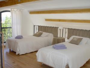 two white beds in a room with a window at La Bastide d'Andrea in Martignargues +42 photos