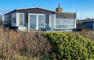 a house with large glass windows and a bush at Nice Home In Esbjerg V With Wifi in Esbjerg