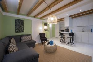 a living room with a couch and a kitchen at Sweet Inn - Corridoni in Milan