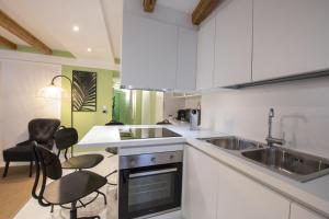 a kitchen with white cabinets and a sink at Sweet Inn - Corridoni in Milan