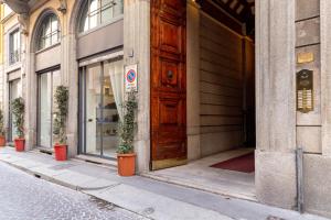 eine Holztür an der Seite eines Gebäudes in der Unterkunft Sweet Inn - Corridoni in Mailand