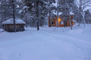 KaamanenにあるHirsi - The White Blue Wilderness Lodgeの雪の中の小屋