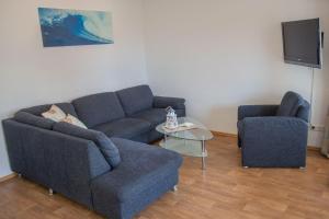 a living room with a couch and a chair at Haus Meeresglück Seemöwe in Dahme