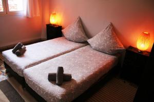 a bedroom with two beds with pillows and two lamps at House Zitouna in Marrakesh