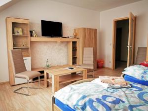 a bedroom with a bed and a table and chairs at Gaestehaus Remde in Erfurt