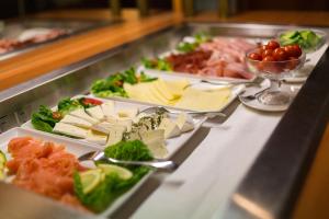 a buffet with several plates of food on a counter at Landhotel Gillenfelder Hof in Gillenfeld