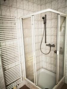 a shower with a glass door in a bathroom at Gaestehaus Remde in Erfurt +24 photos