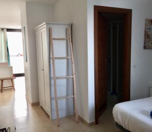 a room with a ladder leaning against a wall at Casa Nemo Cotillo Mar in El Cotillo +2 photos