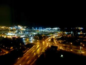 une ville éclairée la nuit avec des lumières de rue dans l'établissement Sea View Apartment in Klaipėda, à Klaipėda