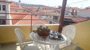 a table with a plate of food on a balcony at Attic of Mary in Nea Roda