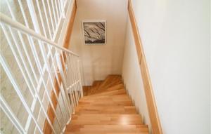 a staircase in a home with white walls and wood floors at Beautiful Apartment In Graal Müritz in Graal-Müritz +5 photos