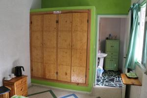 a bathroom with a large wooden cabinet in a room at Riad Les Chtis D'Agadir in Agadir