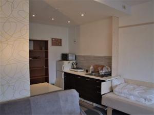a kitchen with a table and a couch in a room at Kaunas Homestay in Kaunas