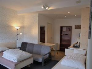 a living room with a couch and a table at Kaunas Homestay in Kaunas