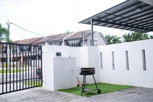 a black stool in front of a white fence at J Residence in Banting