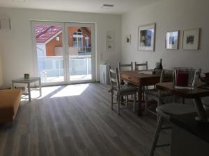 a dining room with a table and chairs and a window at Schönblick in Pfronten