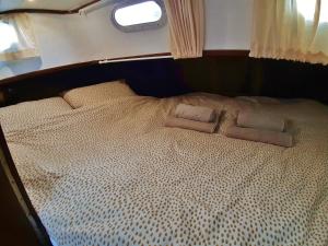 a bed in the middle of a room at Motor Yacht Almaz in Amsterdam
