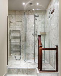 a bathroom with a bath tub and a shower stall at Grand Hotel Praha in Prague