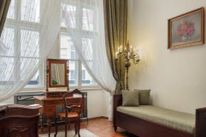 a living room filled with furniture and a window at Grand Hotel Praha in Prague