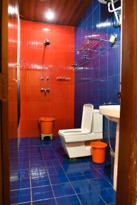 a bathroom with red and blue tiles and a toilet and sink at SB Mount Resort in Lansdowne