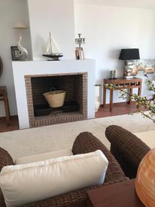 a living room with a couch and a fireplace at Las 2 Lunas in Vélez-Málaga