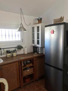 a kitchen with a stainless steel refrigerator and a counter at Las 2 Lunas in Vélez-Málaga