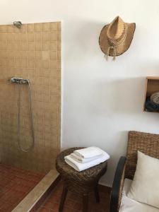 a bathroom with a shower with a table and a chair at Las 2 Lunas in Vélez-Málaga