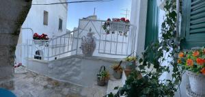 un balcone con fiori e un vaso su un edificio di Panta Rei a Ostuni