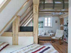 a bedroom with a loft bed and a living room at Über den Dächern der historischen Altstadt in Angermünde