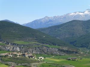 un pueblo en un valle con montañas al fondo en La Solana de Jaca - Casa Oroel, en Novés