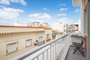 a balcony with white buildings and a blue sky at Casa Mina in Faro