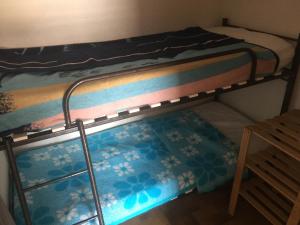 a bottom bunk bed with a mat on the floor at Les Mas De La Mer in Port-la-Nouvelle